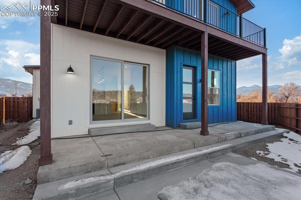 Image 23 of 30: Property entrance with a mountain view, a balcony, and a patio