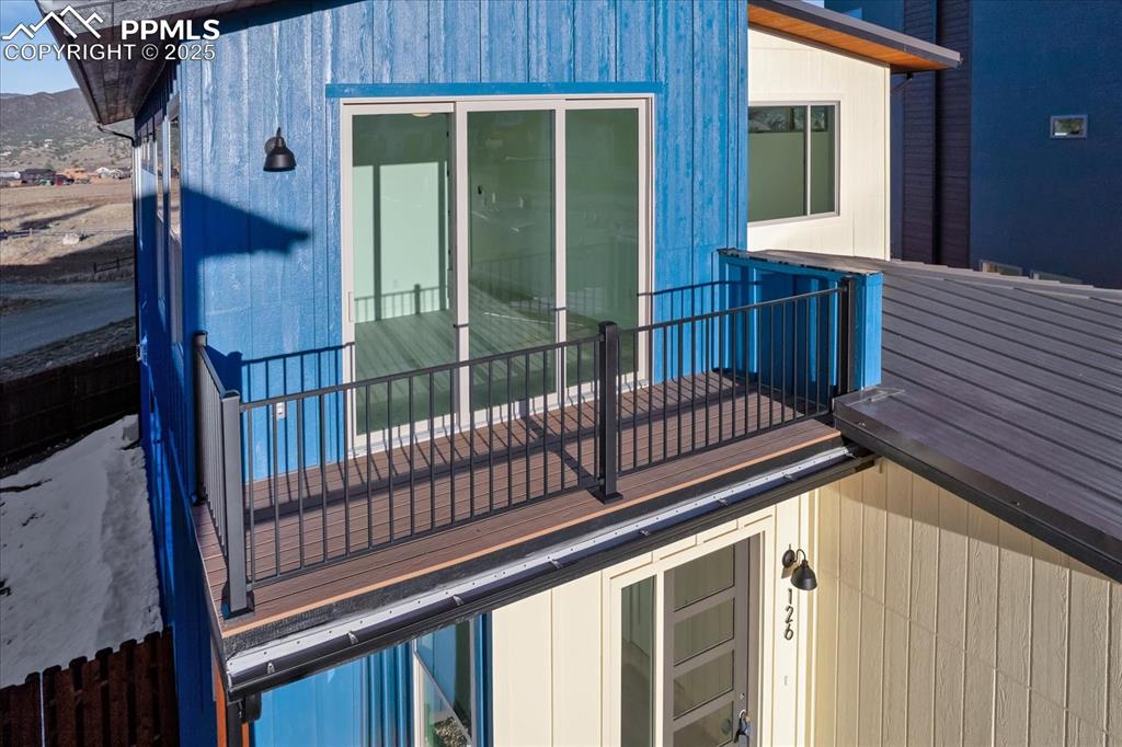 Image 25 of 30: View of side of home featuring a balcony
