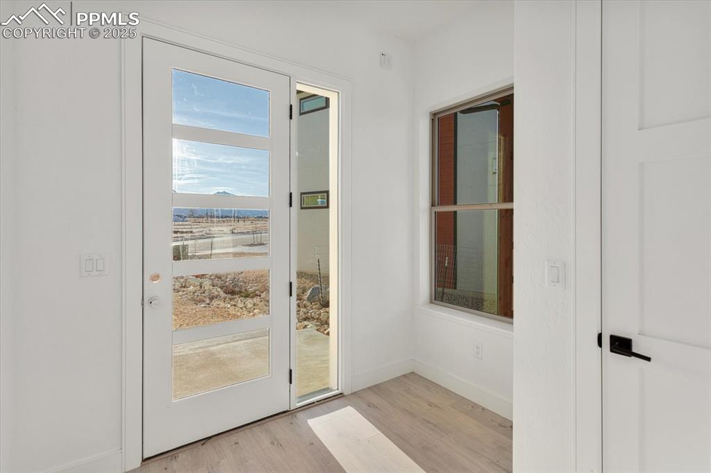 Image 3 of 30: Doorway featuring light hardwood / wood-style flooring