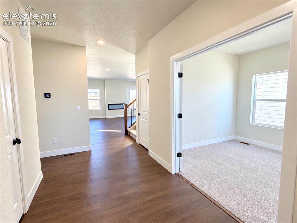 Image 2 of 26: Wood-finish flooring throughout the main entryway
