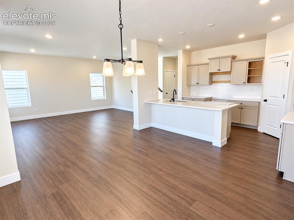 Image 6 of 26: Open-concept living space with wood-finish flooring