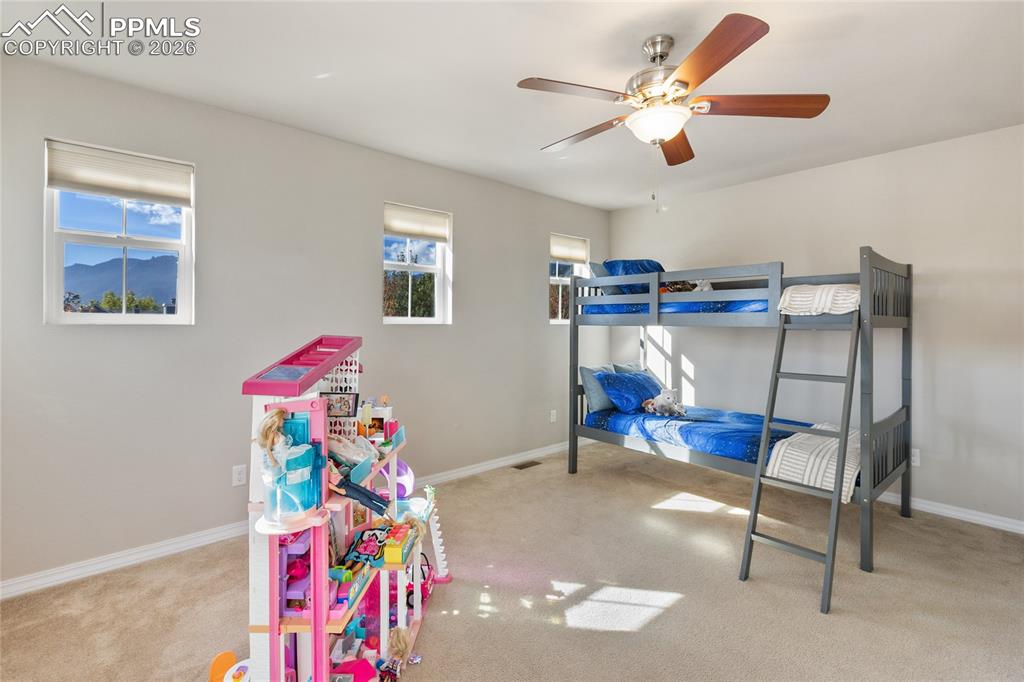 Image 22 of 27: Also on the upper level is another big bedroom with fabulous windows!