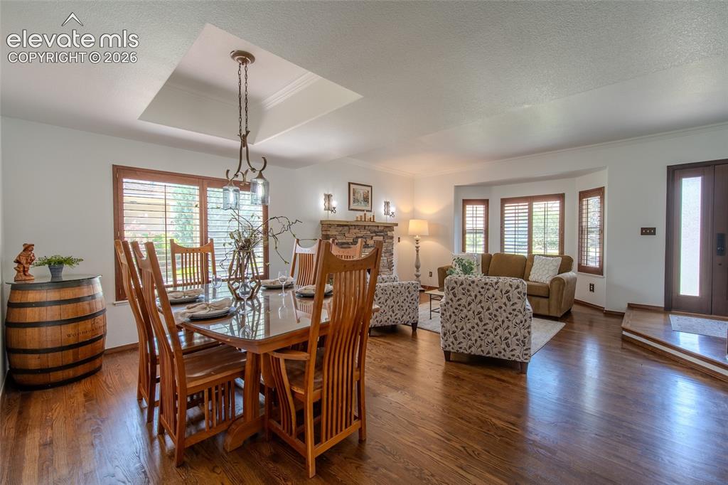 Image 13 of 44: Front entry and open dinning and living with beautiful hardwood floors