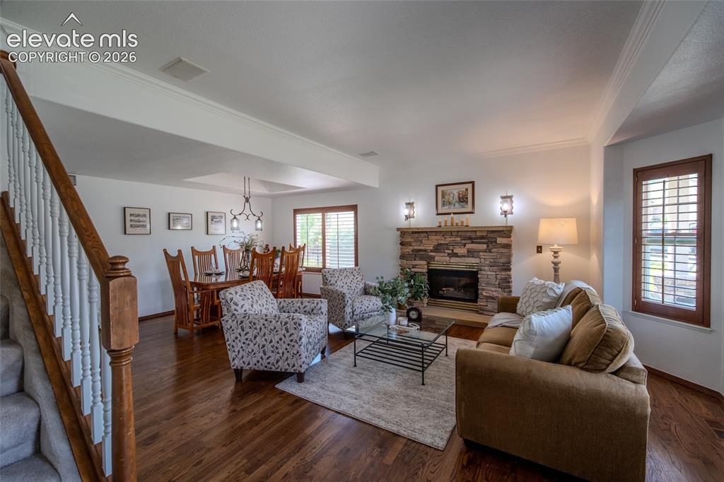 Image 14 of 44: Front entry looking into formal living and dining with gas fireplace