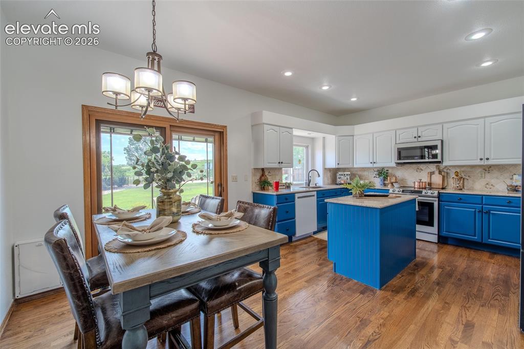 Image 23 of 44: Large kitchen with french door access to back yard