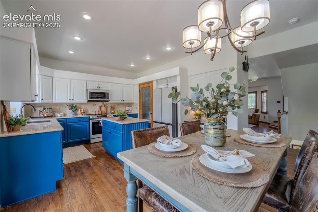 Image 24 of 44: Large open kitchen with natural light flowing into all main floor rooms for