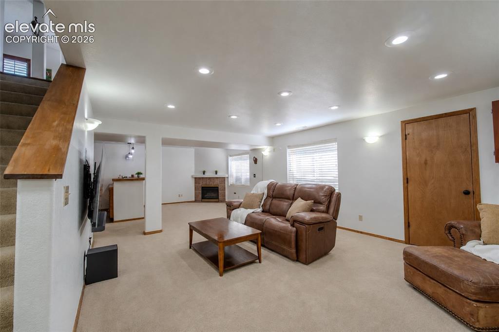 Image 29 of 44: Large Basement with storage and second fireplace w/ wet bar w/ fridge