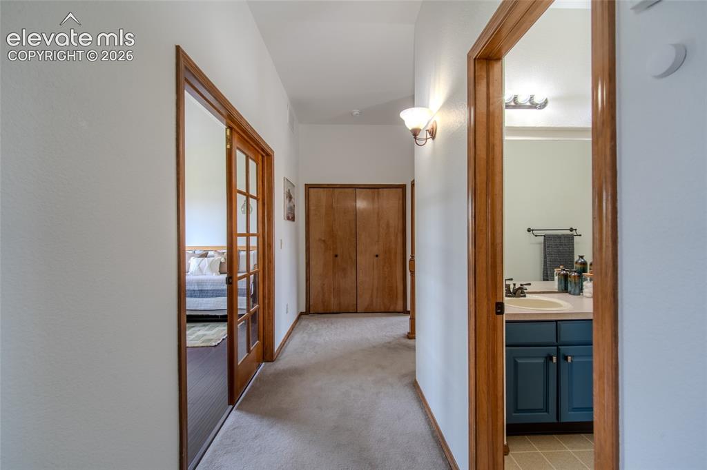 Image 36 of 44: Upstairs w/ view of spare bath with office or bedroom