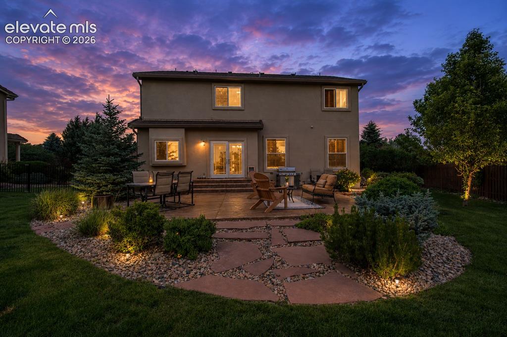 Image 4 of 44: Large concrete stamped patio with views of the mountains and Colorado Sunse