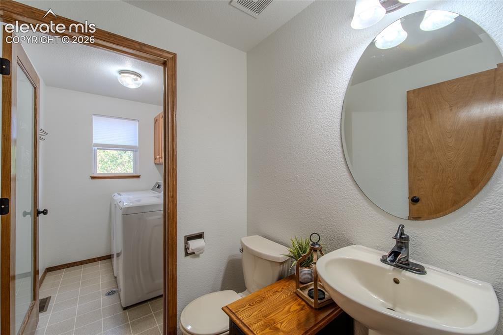 Image 41 of 44: half bath and Laundry located on main floor