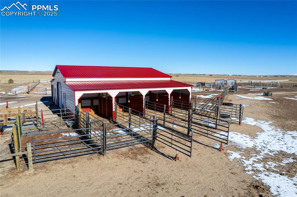 Image 17 of 50: Horse barn featuring a rural view