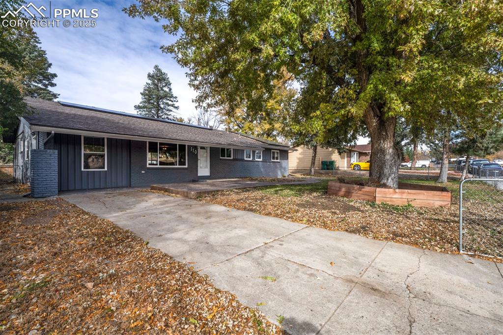 Image 2 of 43: Ranch-style house featuring covered porch, roof with shingles, and brick si