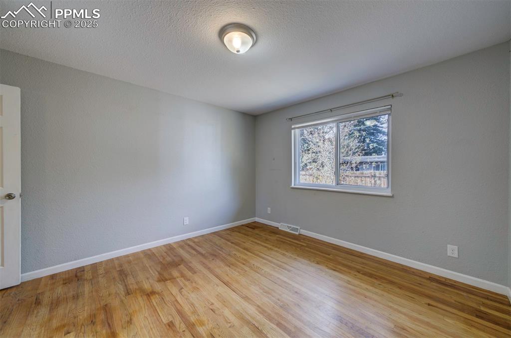 Image 22 of 43: Bedroom featuring wood floor