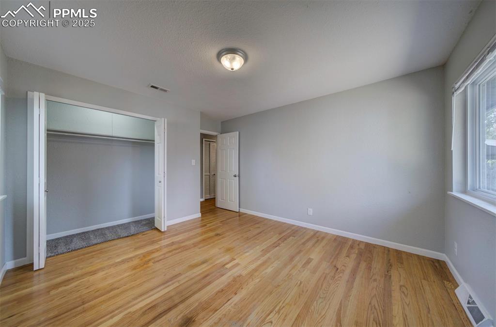 Image 24 of 43: Bedroom featuring wood floor