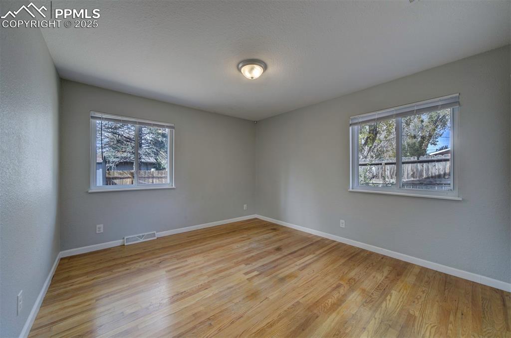 Image 25 of 43: Bedroom featuring wood floor