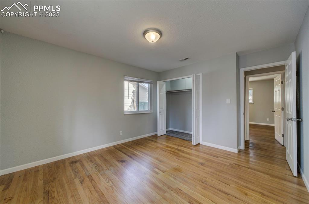 Image 26 of 43: Bedroom featuring wood floor