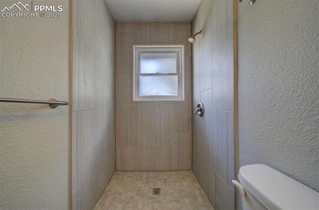 Image 34 of 43: Bathroom featuring a tiled shower