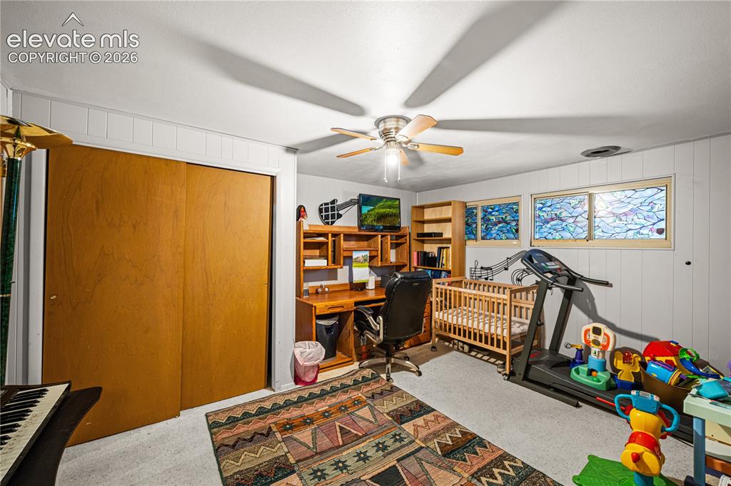 Image 19 of 50: Open-concept living area featuring wood-finish flooring, a pass-through win