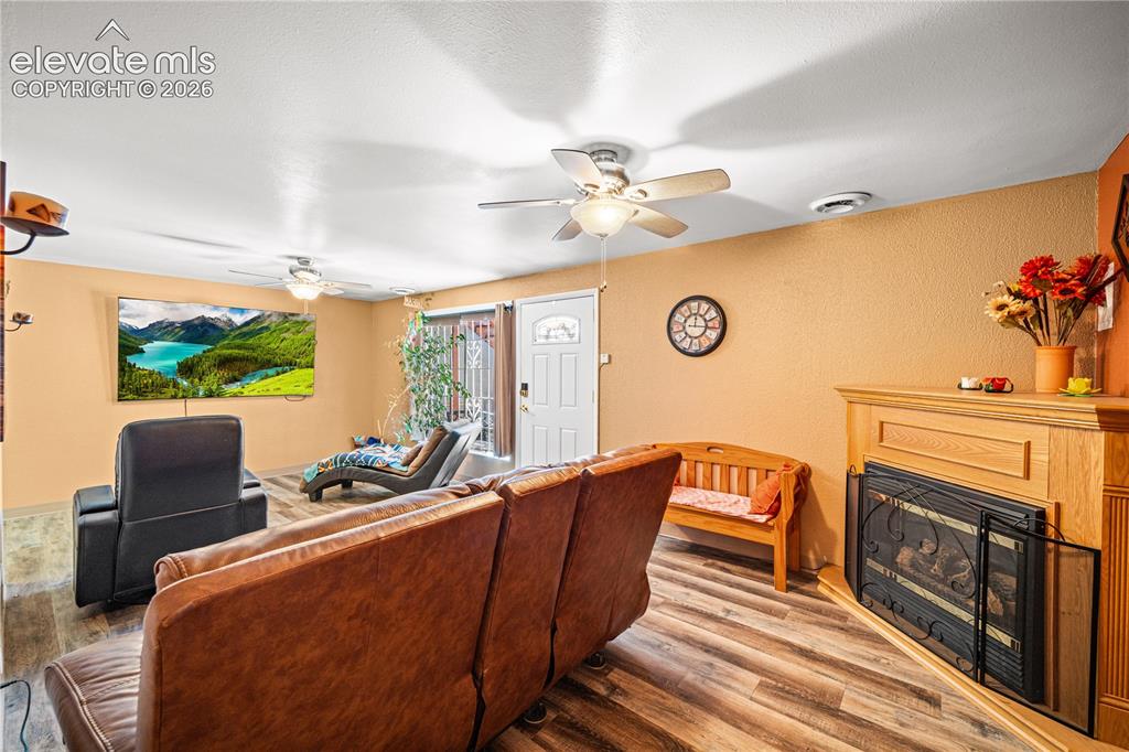 Image 21 of 50: Open concept living space featuring wood-finish flooring, a contemporary ce