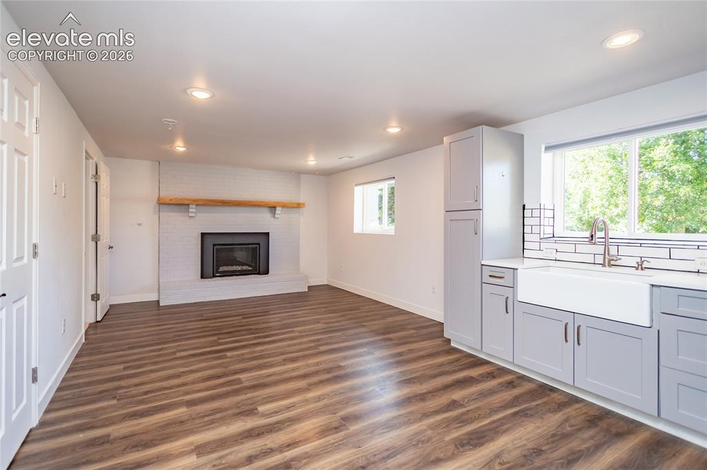 Image 11 of 25: Lower Level Family Room open to second kitchen area