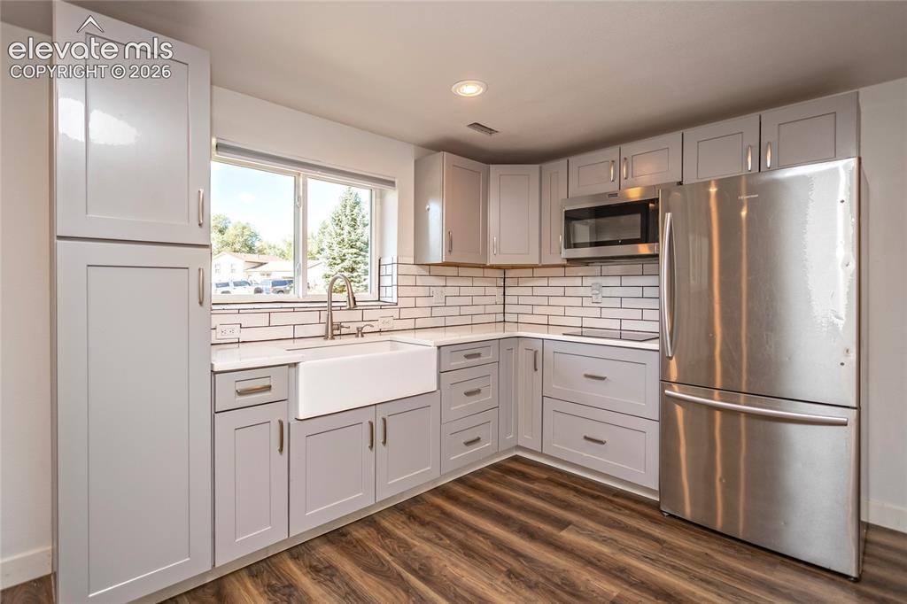 Image 13 of 25: Lower Level Kitchen with convection stove top range