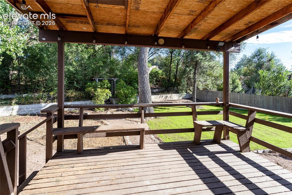 Image 19 of 25: Covered back deck overlooks the large backyard