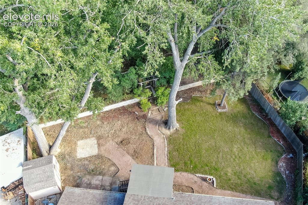 Image 22 of 25: Tiered backyard with storage shed
