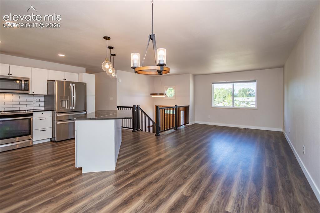 Image 4 of 25: Open Floor Plan of Dining Area, Kitchen, and Living Room