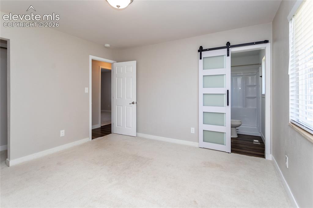 Image 7 of 25: Primary Bedroom with adjoining private bath