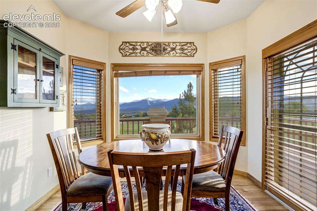 Image 11 of 49: Eat-in kitchen nook with views and deck access