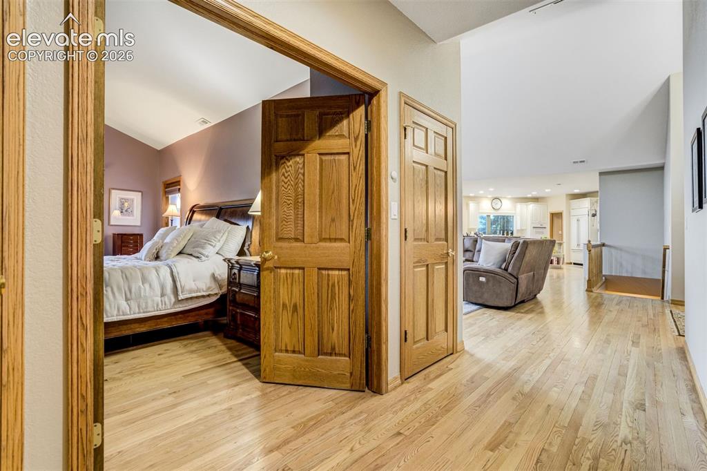 Image 16 of 49: The wood extends down the hallway into the Primary Suite