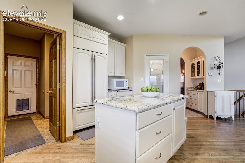 Image 28 of 49: Off the kitchen is the hall to the laundry room, 1/2 bathroom, and garage