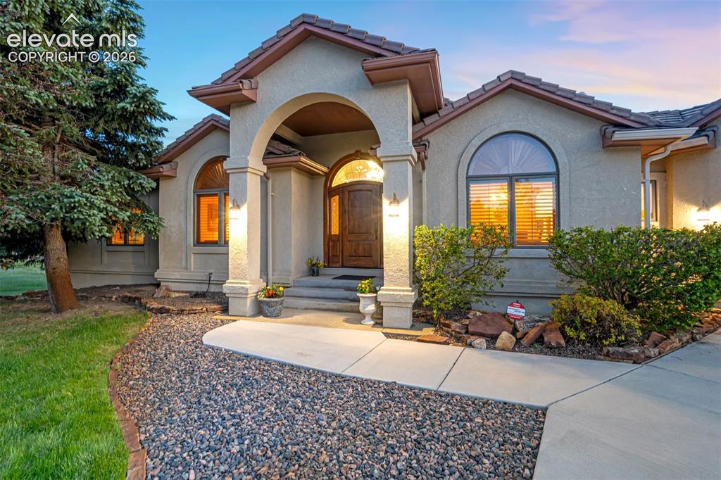 Image 3 of 49: Stately entrance with a covered porch