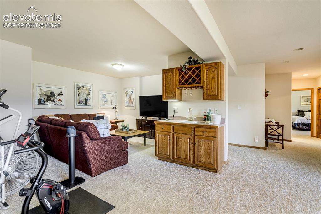 Image 36 of 49: A wet bar in the basement is ideal for entertaining!