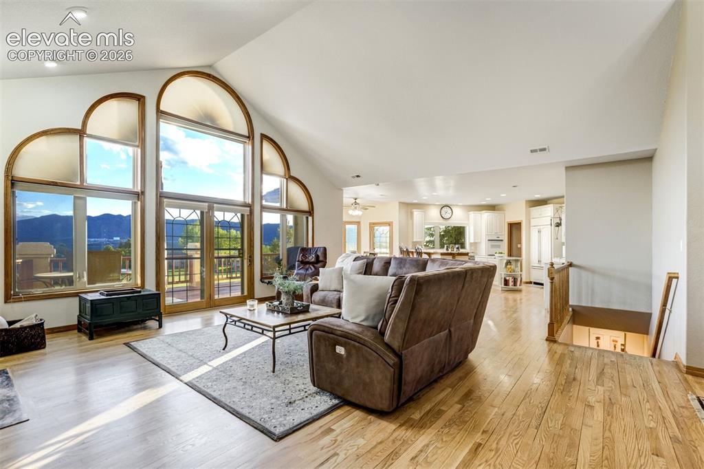 Image 6 of 49: Gorgeous soaring ceilings and floor to ceiling windows highlight the front