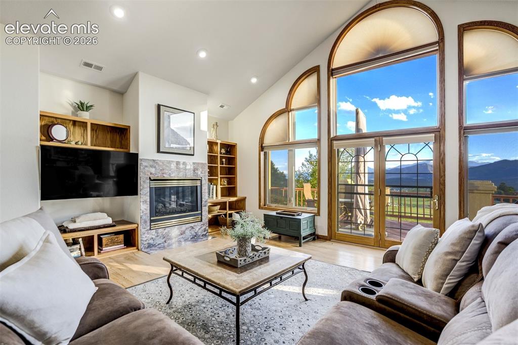 Image 7 of 49: A cozy fireplace provides the ideal space to enjoy these views!