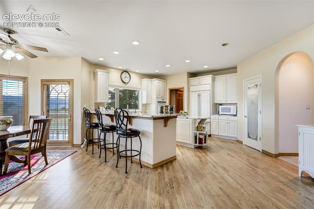 Image 9 of 49: Remodeled kitchen with counter seating, island, walk-in pantry, and SubZero