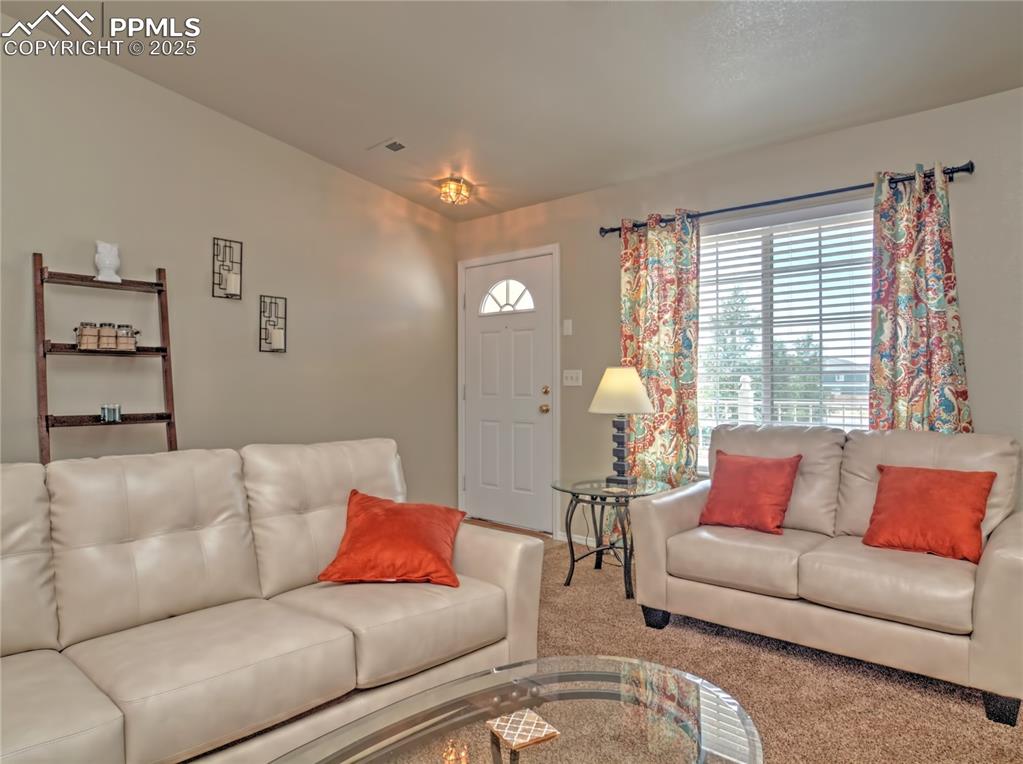 Image 2 of 24: Living room with carpet floors
