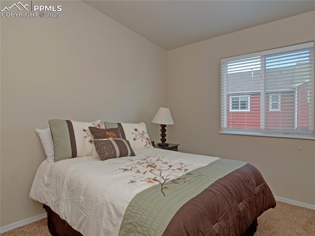 Image 21 of 24: Bedroom with carpet flooring and baseboards