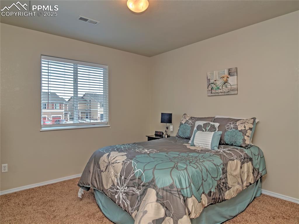 Image 22 of 24: Carpeted bedroom with baseboards