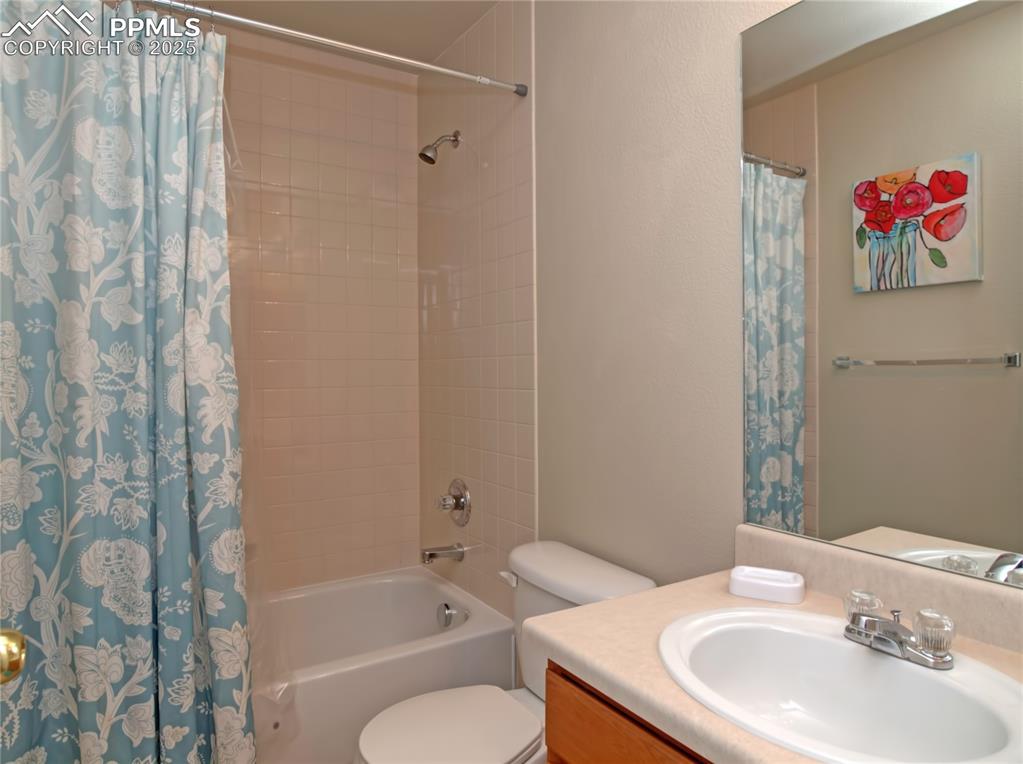 Image 23 of 24: Full bathroom with shower / bath combo, vanity, and a textured wall