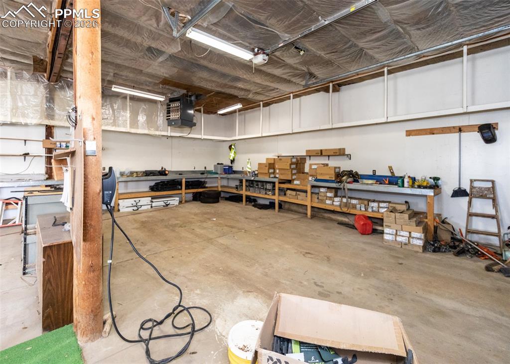 Image 38 of 47: Garage with a workshop area