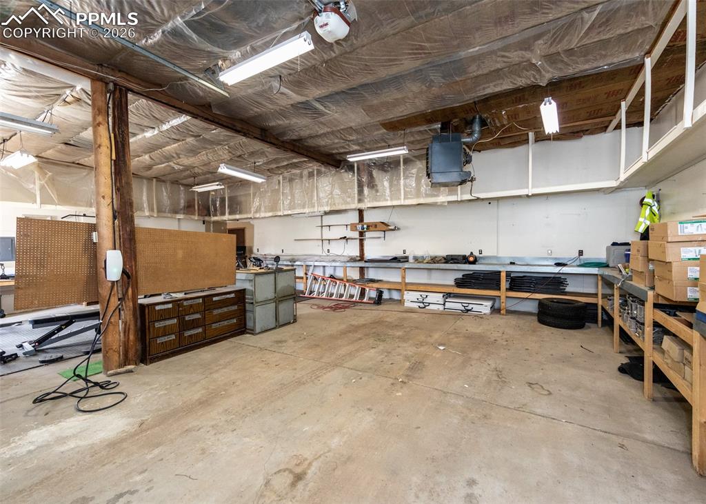 Image 39 of 47: Garage with a workshop area