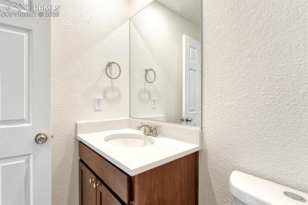 Image 11 of 34: Half bath with your choice of cabinetry and countertop is on the main level