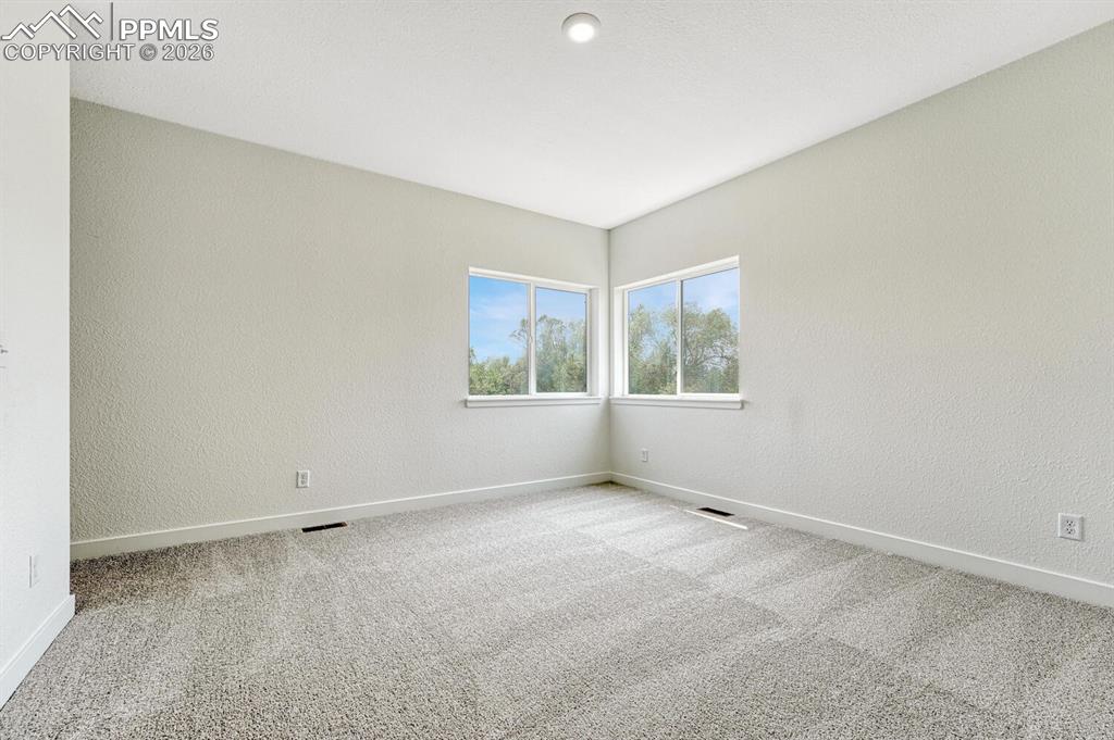 Image 12 of 34: 9 ft ceilings on the upper level. Primary bedroom glows with natural light.