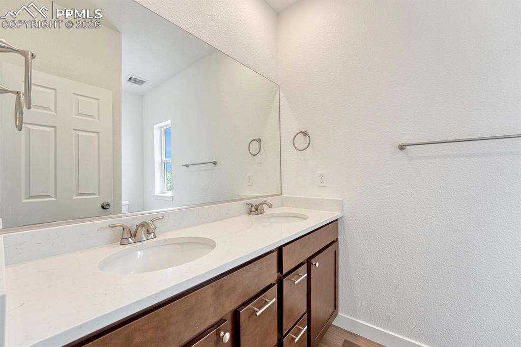 Image 14 of 34: En suite primary bathroom offers double vanity with undermount sinks. Pick