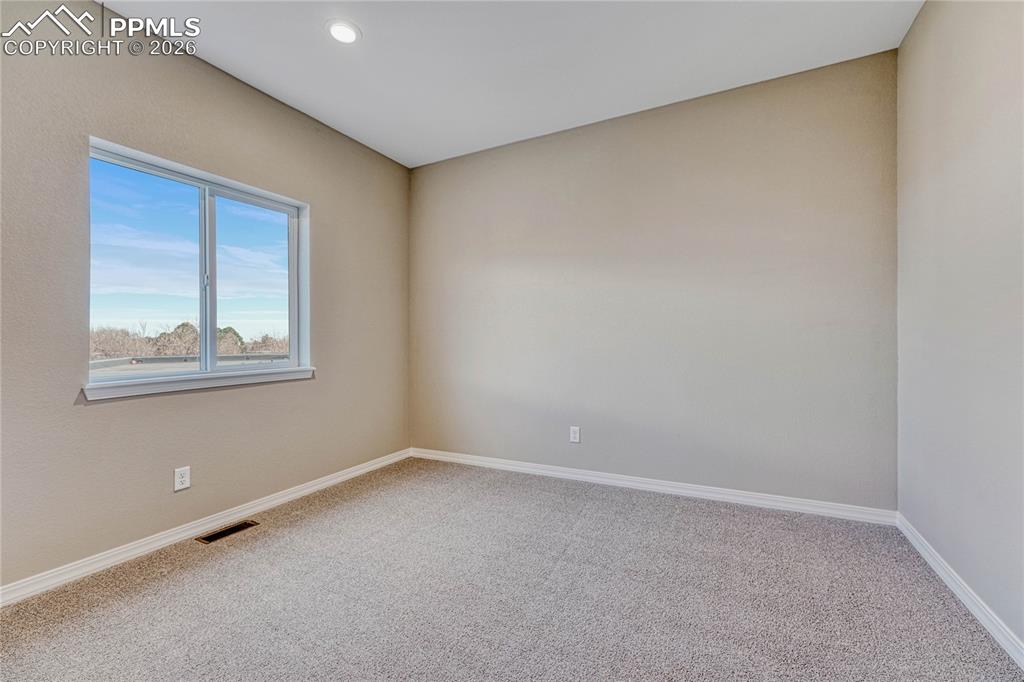 Image 16 of 34: Two secondary bedrooms on upper level.