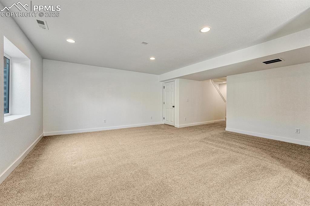Image 20 of 34: Generously sized rec room is pre-plumbed for a wet bar.