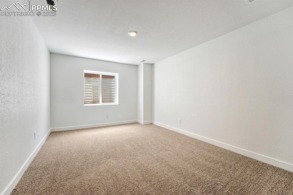 Image 22 of 34: Fourth bedroom in the basement is perfect for guests or generational living