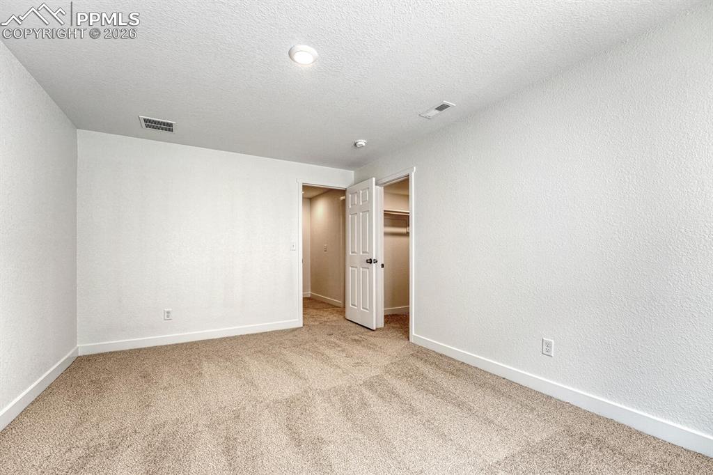 Image 23 of 34: Walk-in closet for use as a wardrobe or extra storage.